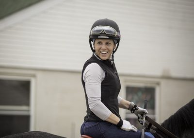 Exercise rider Kara Lee heads to the track for a morning workout.