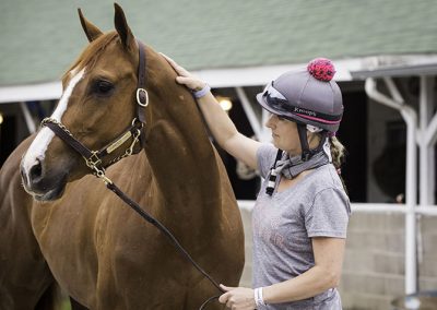 Exercise rider and local Pilates instructor, Jo Trout, with Purrfect Love. "My favorite horse just got claimed by another owner, so it's been a rough week."